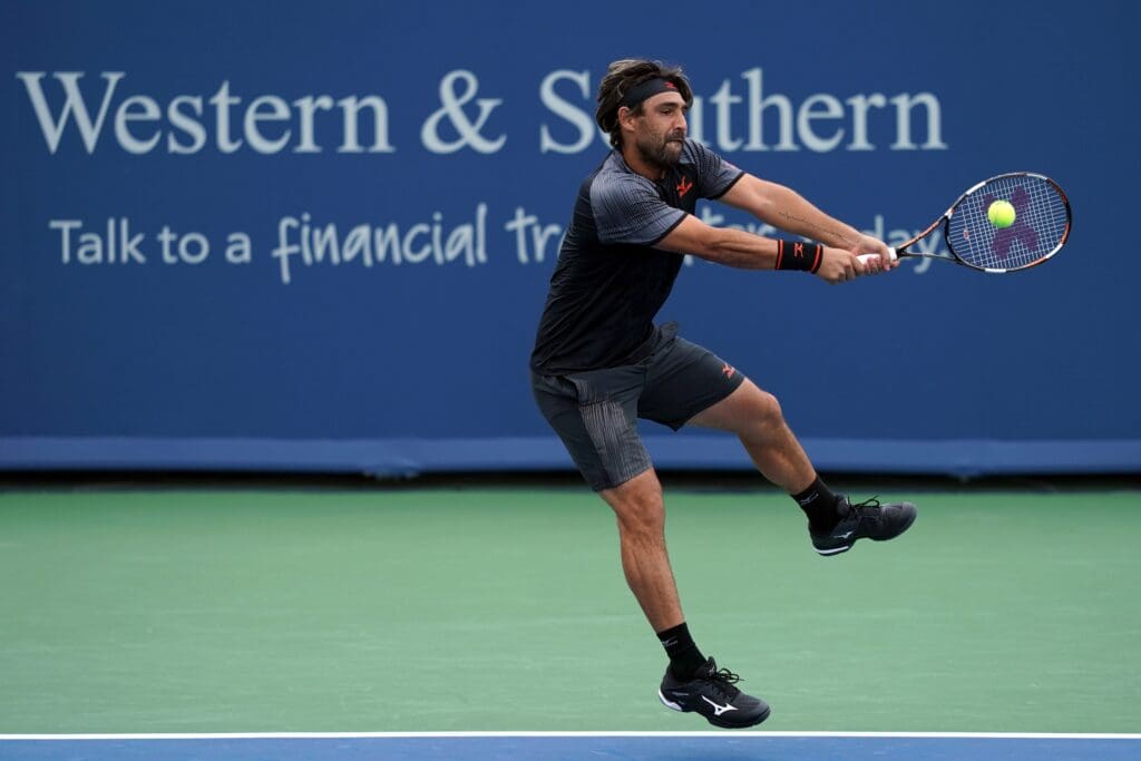 Aug 11, 2018; Mason, OH, USA; Marcos Baghdatis (CYP) returns a shot against Feliciano Lopez (ESP) in the Western and Southern tennis open at Lindner Family Tennis Center. Mandatory Credit: Aaron Doster-USA TODAY Sports