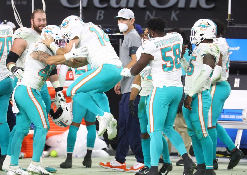 Dec 26, 2020; Paradise, Nevada, USA; Miami Dolphins quarterback Ryan Fitzpatrick (14) reacts after kicker Jason Sanders (7) makes a field goal for the victory against the Las Vegas Raiders during the second half at Allegiant Stadium. Mandatory Credit: Mark J. Rebilas-USA TODAY Sports