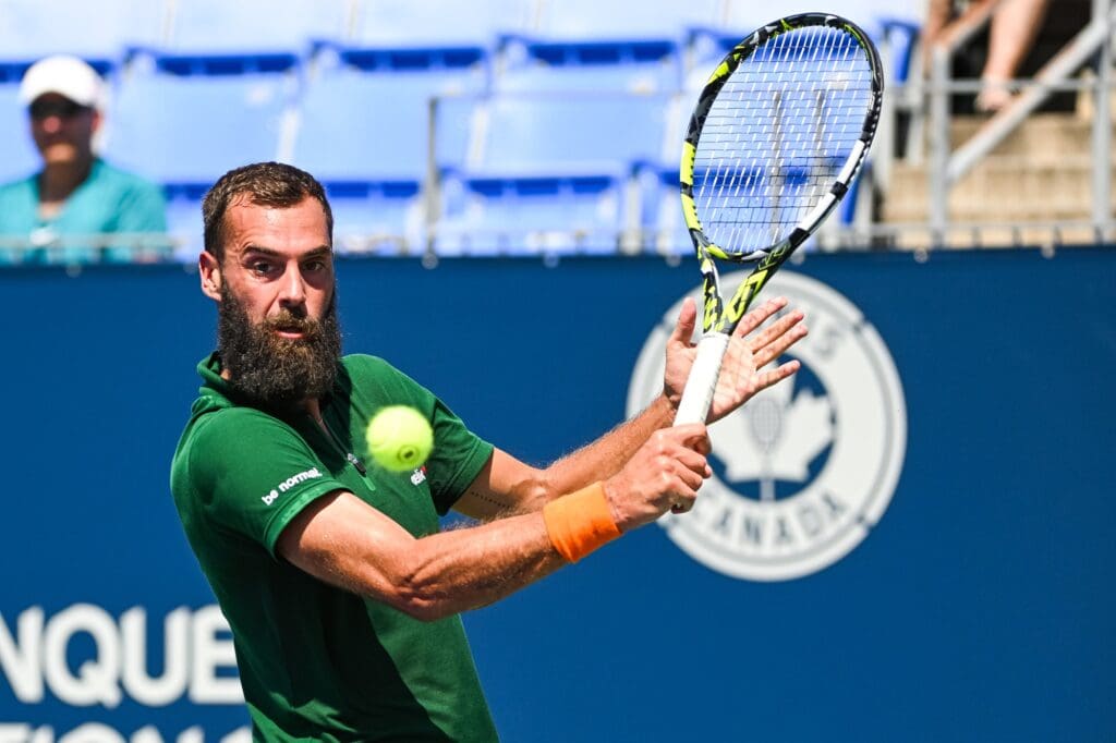 Aug 7, 2022; Montreal, Quebec, Canada; Benoit Paire (FRA) hits a shot against Marc-Andrea Huesler (SUI) (not pictured) in second round qualifying play at IGA Stadium. Mandatory Credit: David Kirouac-USA TODAY Sports