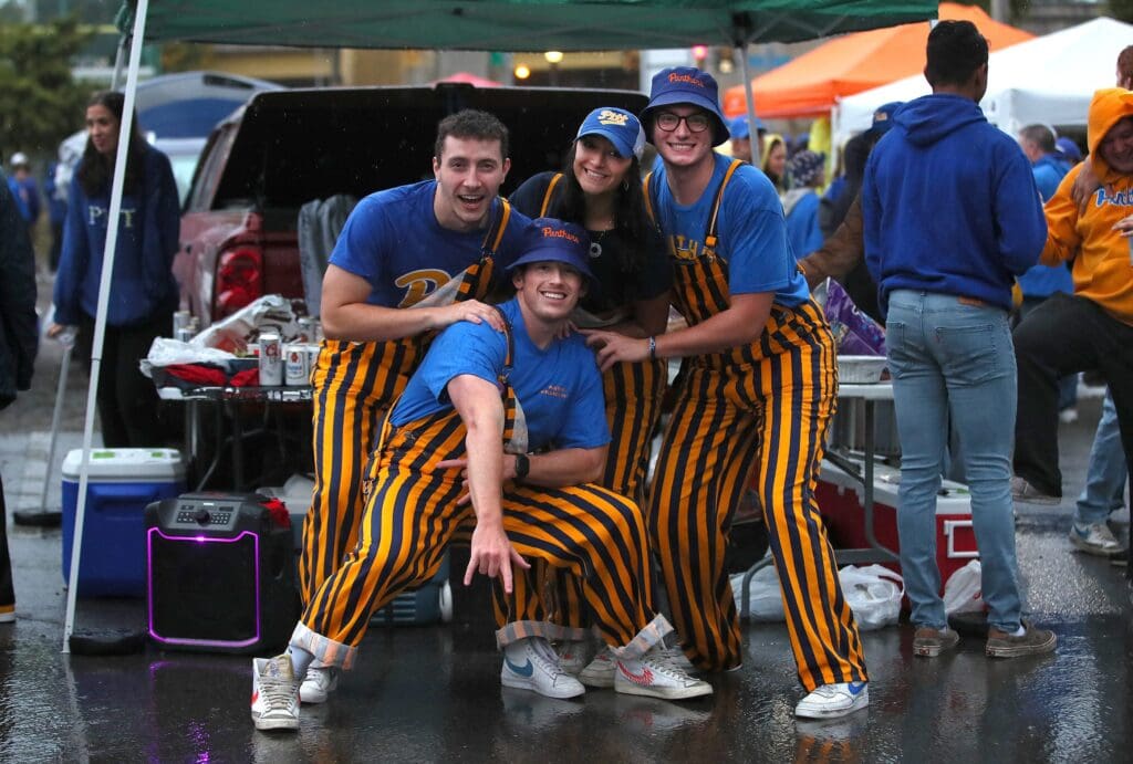Students from the University of Pittsburgh pose for a photo while tailgating outside of Acrisure Stadium prior to the start of the game against the North Carolina Tar Heels in Pittsburgh, PA on September 23, 2023.