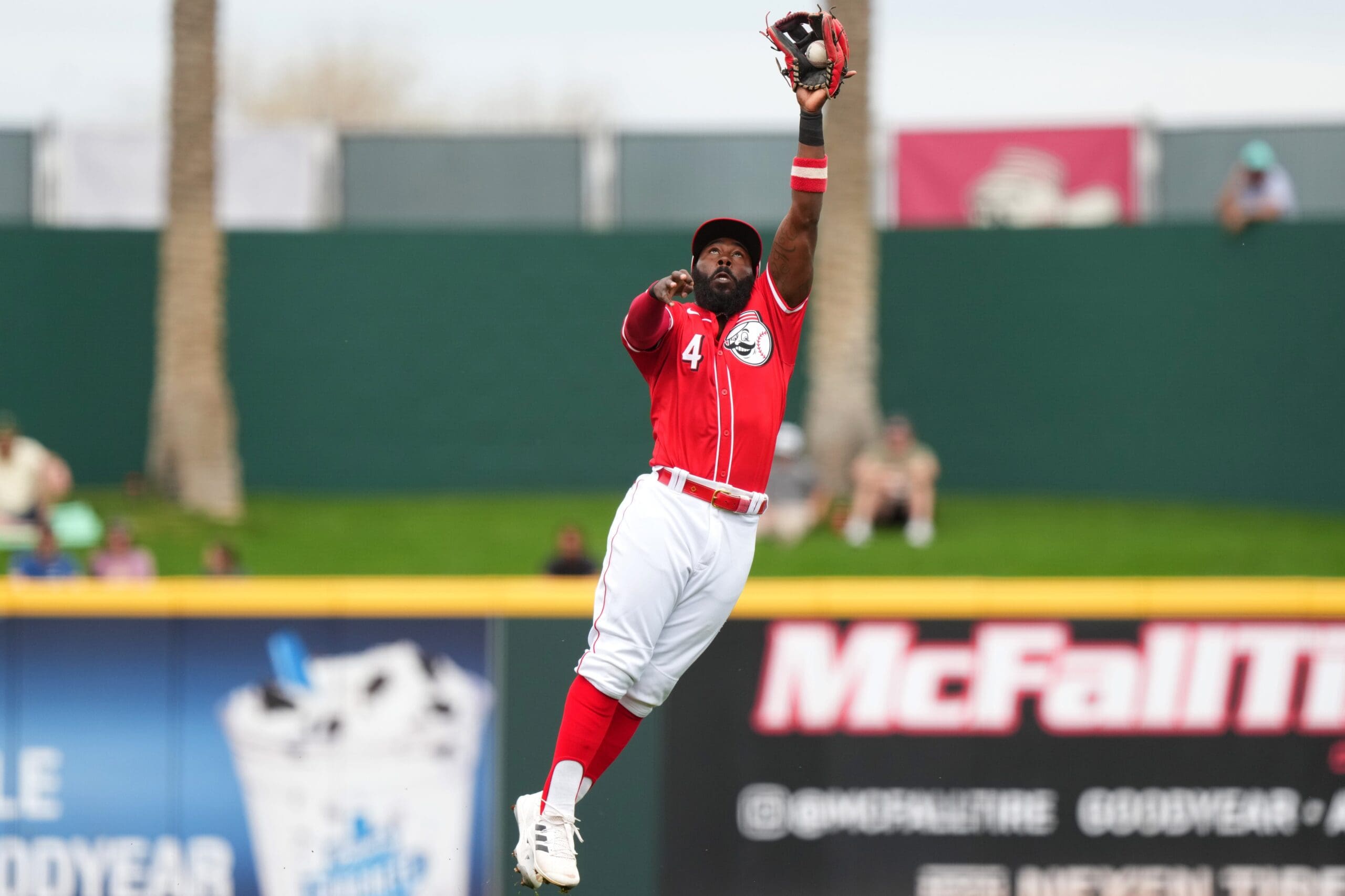 Cincinnati Reds second baseman Josh Harrison leaps to catch a line drive for an out in the first inning during a MLB spring training baseball game against the Seattle Mariners, Monday, Feb. 26, 2024, at Goodyear Ballpark in Goodyear, Ariz.