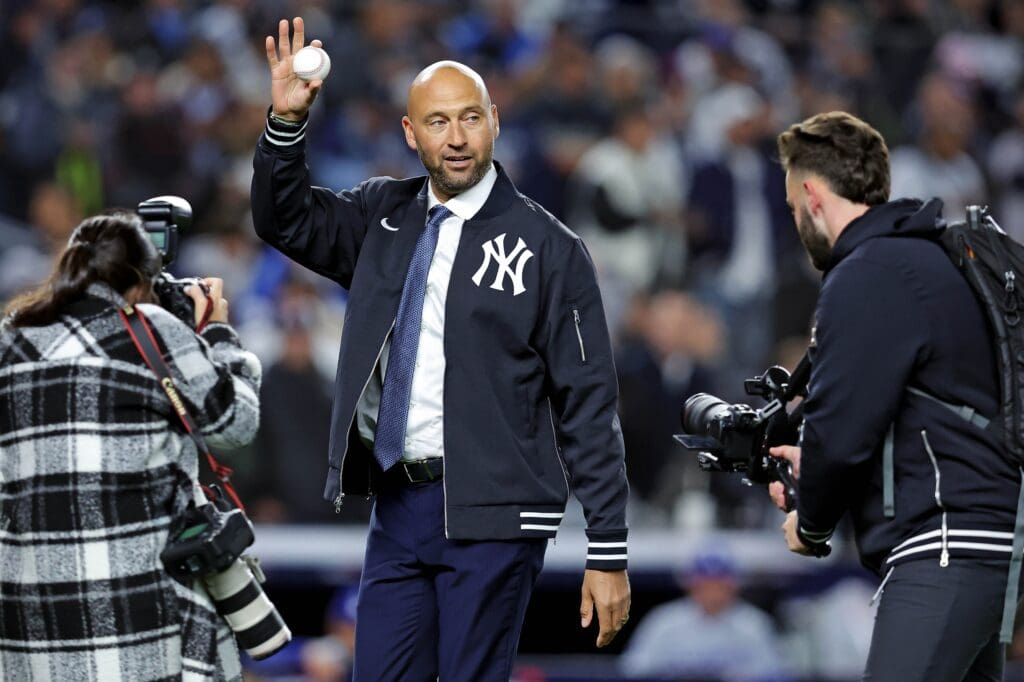 Oct 28, 2024; New York, New York, USA; New York Yankees former playing Derek Jeter waves to fans before throwing out the ceremonial first pitch before game three of the 2024 MLB World Series between the New York Yankees and the Los Angeles Dodgers at Yankee Stadium. Mandatory Credit: Brad Penner-Imagn Images