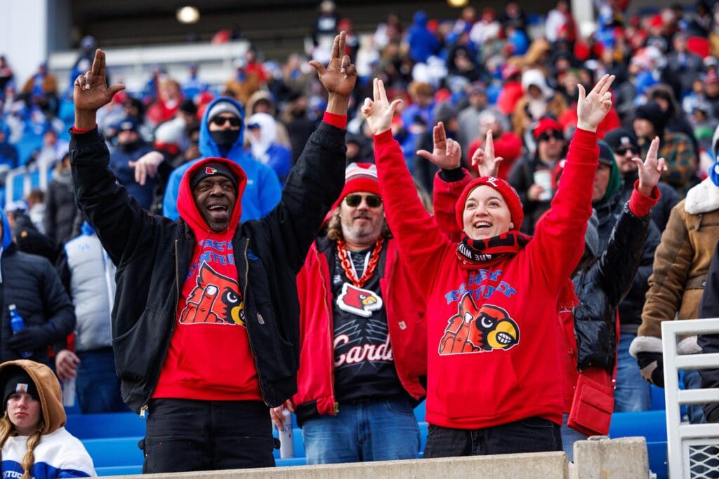 Nov 30, 2024; Lexington, Kentucky, USA; Louisville Cardinals fans cheer during the third quarter against the Kentucky Wildcats at Kroger Field. Mandatory Credit: Jordan Prather-Imagn Images