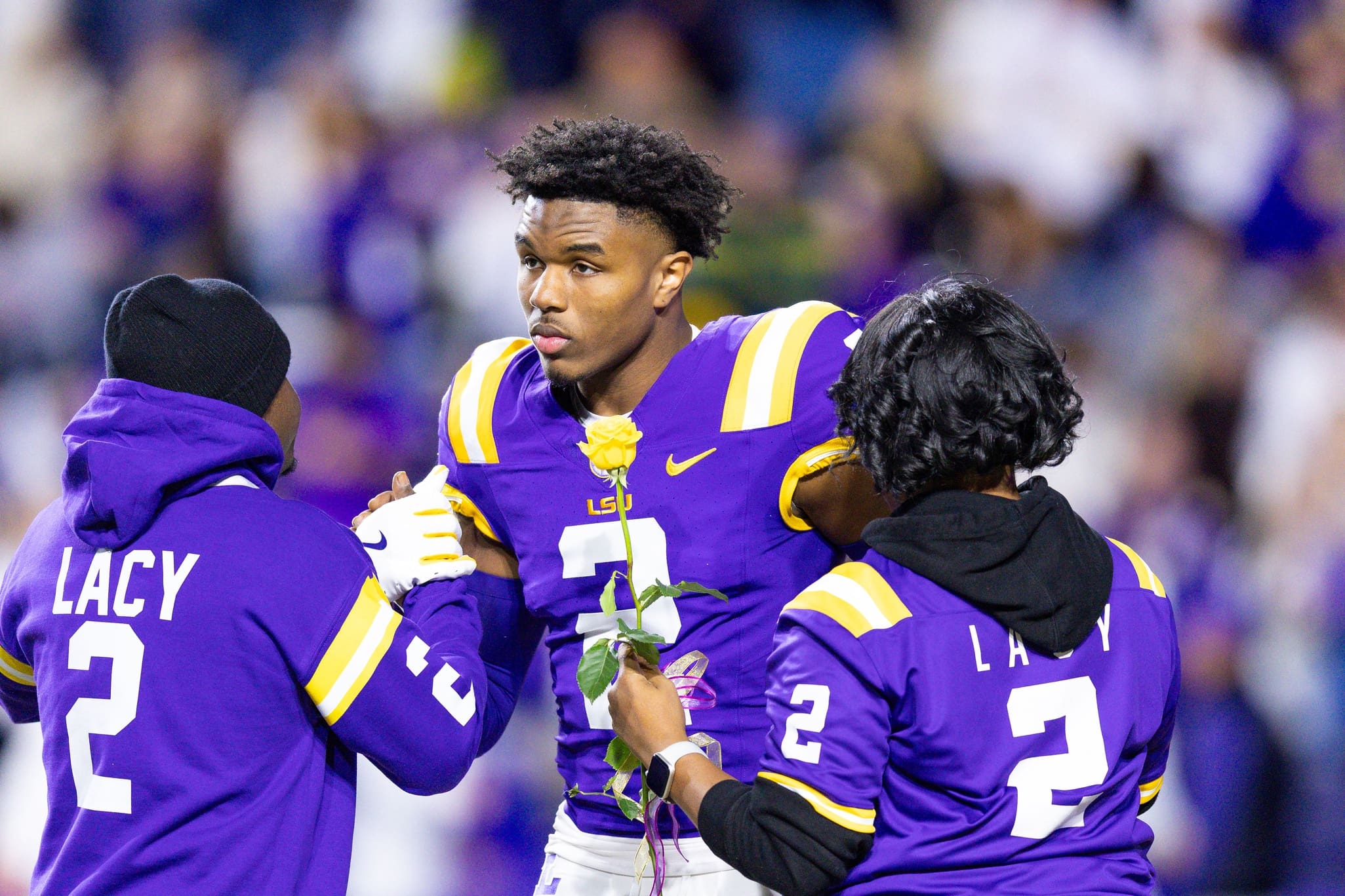 Nov 30, 2024; Baton Rouge, Louisiana, USA; LSU Tigers wide receiver Kyren Lacy (2) hugs his family as seniors are being honored during the beginning of the first quarter at Tiger Stadium. Mandatory Credit: Stephen Lew-Imagn Images