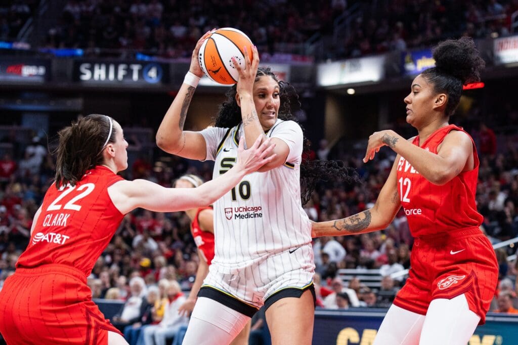May 17, 2025; Indianapolis, Indiana, USA; Chicago Sky center Kamilla Cardoso (10) holds the ball while Indiana Fever guard Caitlin Clark (22) defends in the second half at Gainbridge Fieldhouse. Mandatory Credit: Trevor Ruszkowski-Imagn Images