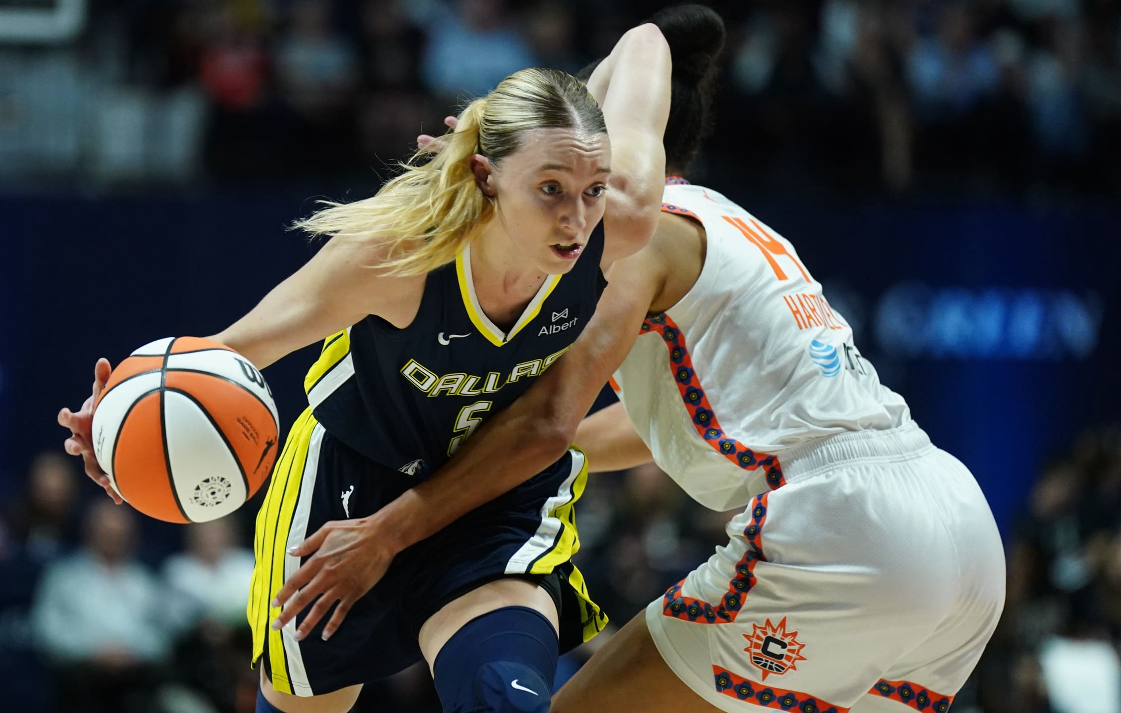 May 27, 2025; Uncasville, Connecticut, USA; Dallas Wings guard Paige Bueckers (5) drives the ball against Connecticut Sun guard Bria Hartley (14) in the first half at Mohegan Sun Arena. Mandatory Credit: David Butler II-Imagn Images