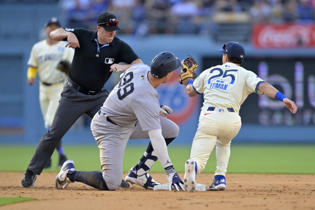 May 31, 2025; Los Angeles, California, USA; Umpire Brennan Miller (55) calls New York Yankees right fielder Aaron Judge (99) out on a tag by Los Angeles Dodgers second baseman Tommy Edman (25) in the seventh inning at Dodger Stadium. Mandatory Credit: Jayne Kamin-Oncea-Imagn Images