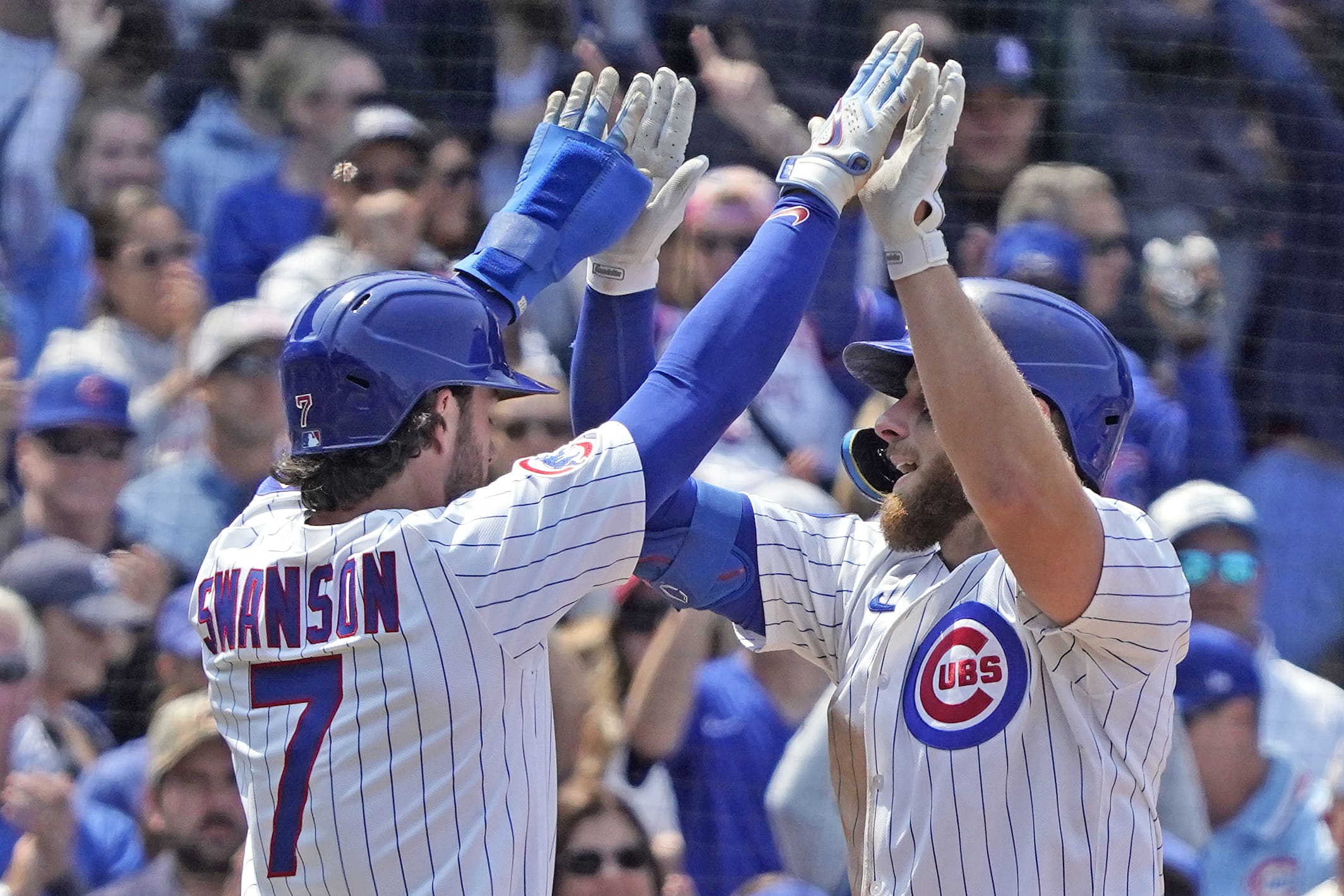 Jun 1, 2025; Chicago, Illinois, USA; Chicago Cubs first baseman Michael Busch (29) is greeted by shortstop Dansby Swanson (7) after hitting a two-run home run against the Cincinnati Reds during the third inning at Wrigley Field. Mandatory Credit: David Banks-Imagn Images