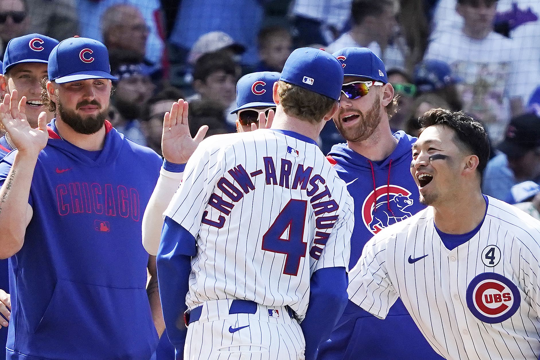 Jun 1, 2025; Chicago, Illinois, USA; Chicago Cubs outfielder Pete Crow-Armstrong (4), outfielder Seiya Suzuki (right) and teammates celebrate their win against the Cincinnati Reds at Wrigley Field. Mandatory Credit: David Banks-Imagn Images