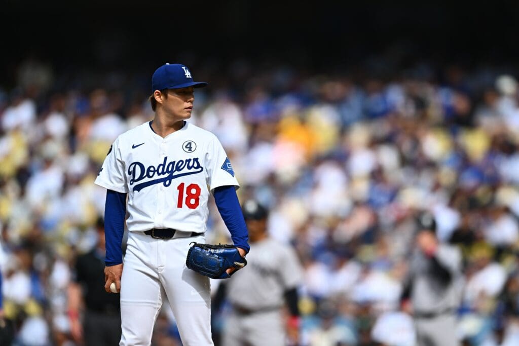 Jun 1, 2025; Los Angeles, California, USA; Los Angeles Dodgers starting pitcher Yoshinobu Yamamoto (18) on the mound against the New York Yankees during the first inning at Dodger Stadium. Mandatory Credit: Jonathan Hui-Imagn Images