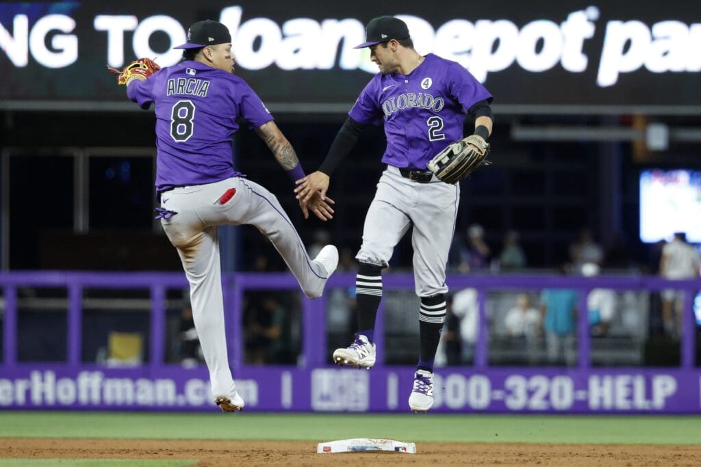 Jun 2, 2025; Miami, Florida, USA; Colorado Rockies short stop Orlando Arcia (8) and right fielder Tyler Freeman (2) celebrate their win against the Miami Marlins following the game at loanDepot Park. Mandatory Credit: Rhona Wise-Imagn Images