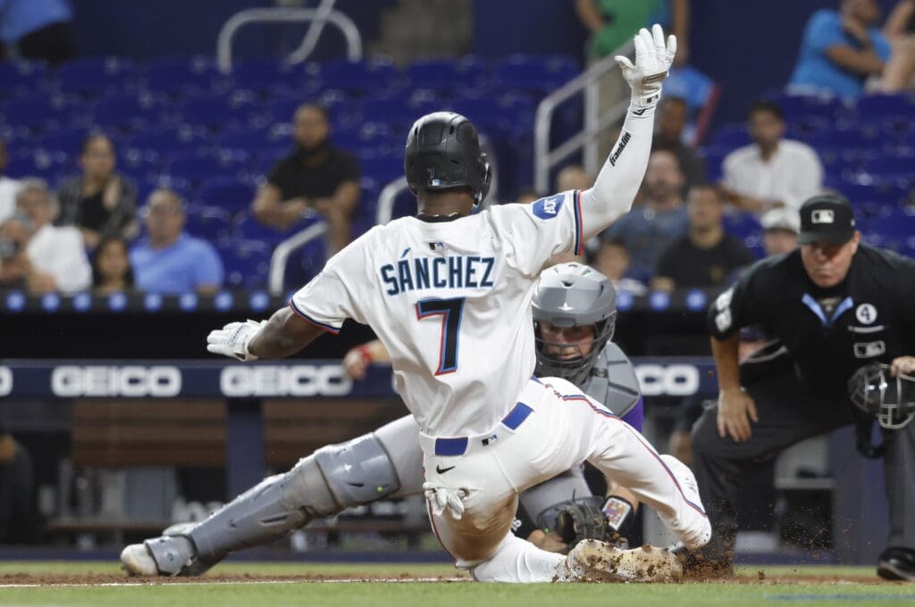 Jun 2, 2025; Miami, Florida, USA; Colorado Rockies catcher Hunter Goodman (15) waits to tag Miami Marlins right fielder Jesus Sanchez (7) out at the plate during the second inning at loanDepot Park. Mandatory Credit: Rhona Wise-Imagn Images