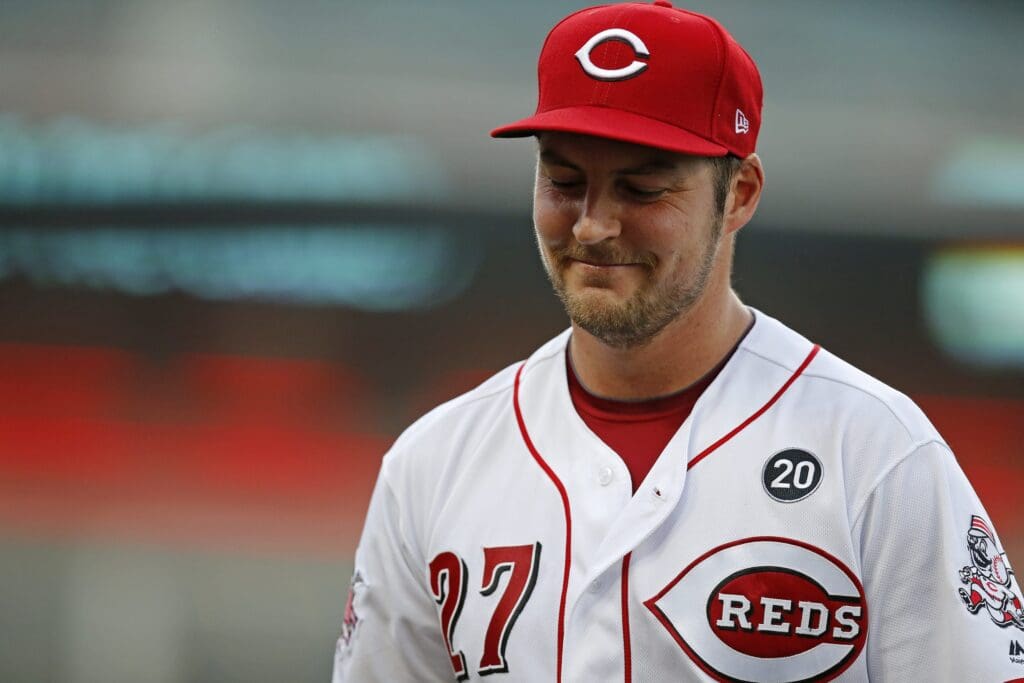 Cincinnati Reds starting pitcher Trevor Bauer (27) smiles as he returns to the dugout after the first inning against the San Diego Padres at Great American Ball Park on Aug. 19, 2019.
