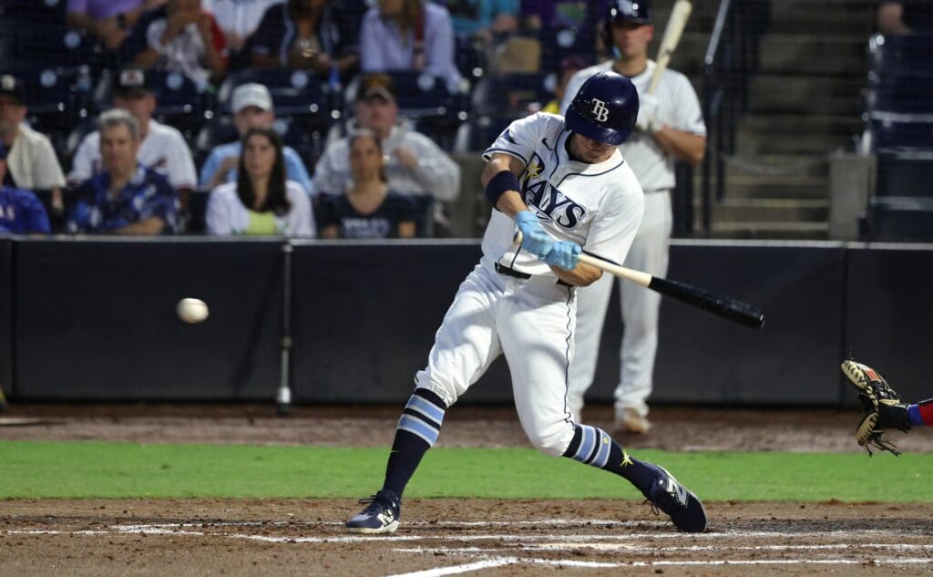 Jun 4, 2025; St. Petersburg, Florida, USA; Tampa Bay Rays outfielder Jake Mangum (28) hits an RBI single against the Texas Rangers during the third inning at George M. Steinbrenner Field. Mandatory Credit: Kim Klement Neitzel-Imagn Images