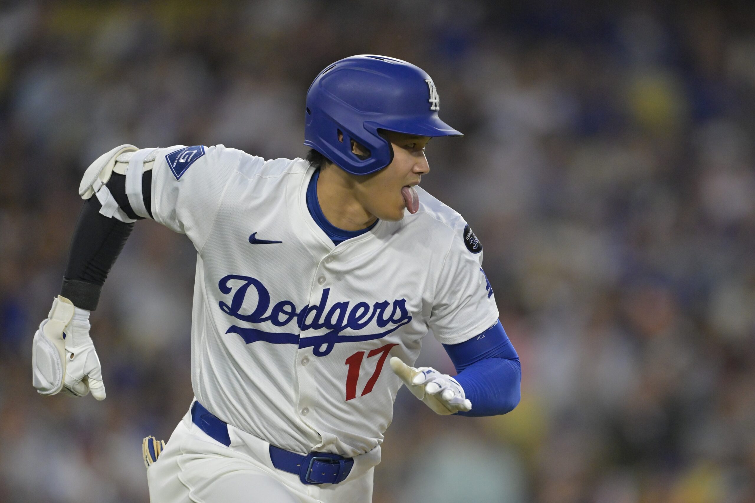 Jun 4, 2025; Los Angeles, California, USA; Los Angeles Dodgers two-way player Shohei Ohtani (17) singles in the third inning against the New York Mets at Dodger Stadium. Mandatory Credit: Jayne Kamin-Oncea-Imagn Images