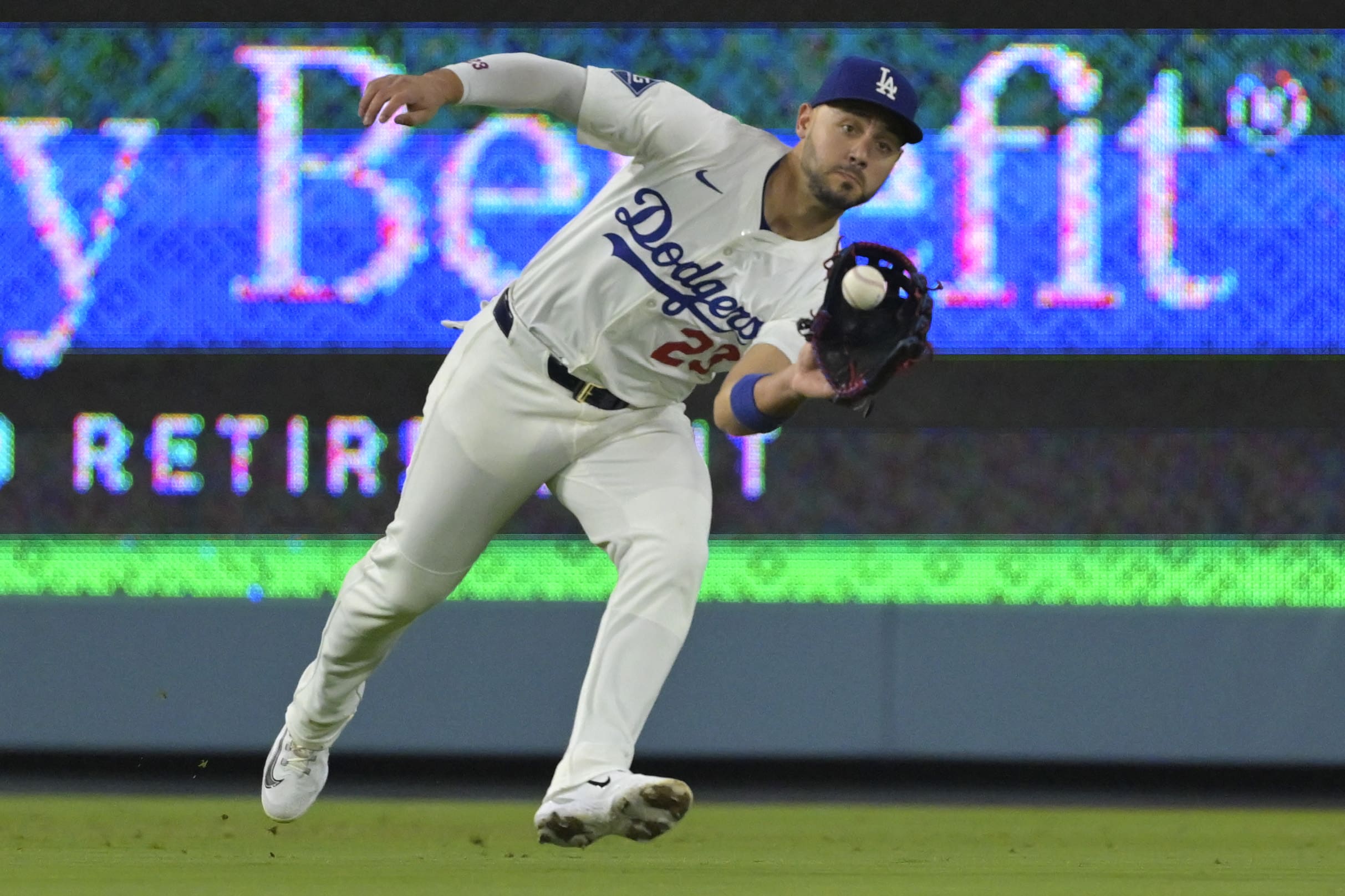 Jun 4, 2025; Los Angeles, California, USA; Los Angeles Dodgers left fielder Michael Conforto (23) makes a running catch off New York Mets third baseman Brett Baty (7) in the fifth inning at Dodger Stadium. Mandatory Credit: Jayne Kamin-Oncea-Imagn Images
