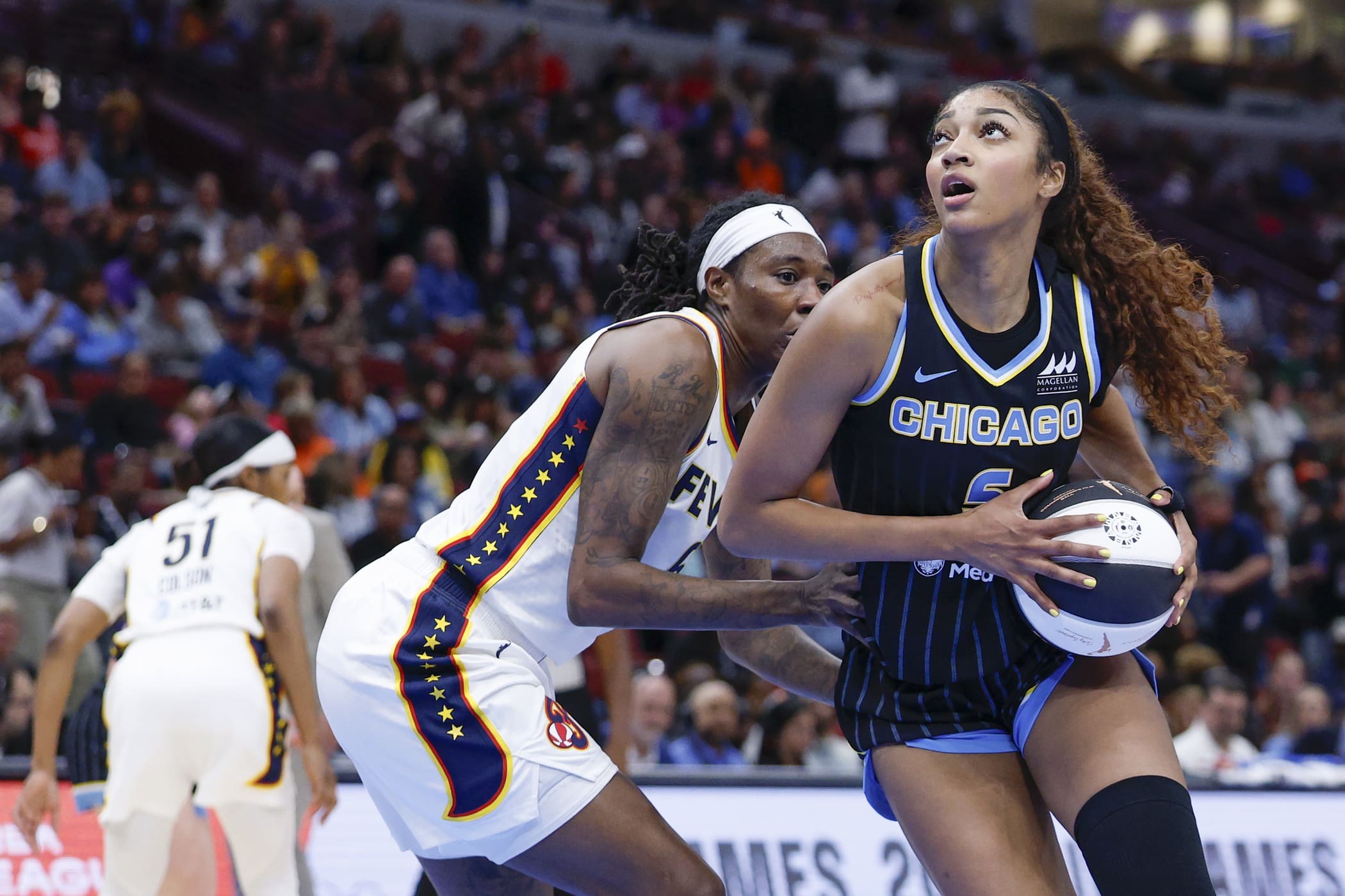 Jun 7, 2025; Chicago, Illinois, USA; Chicago Sky forward Angel Reese (5) drives to the basket against Indiana Fever forward Natasha Howard (6) during the second half of a WNBA game at United Center. Mandatory Credit: Kamil Krzaczynski-Imagn Images