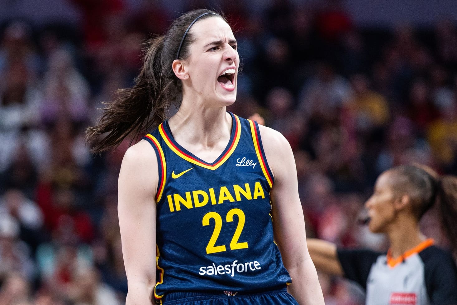Jun 14, 2025; Indianapolis, Indiana, USA; Indiana Fever guard Caitlin Clark (22) celebrates a made basket in the first half against the New York Liberty at Gainbridge Fieldhouse. Mandatory Credit: Trevor Ruszkowski-Imagn Images