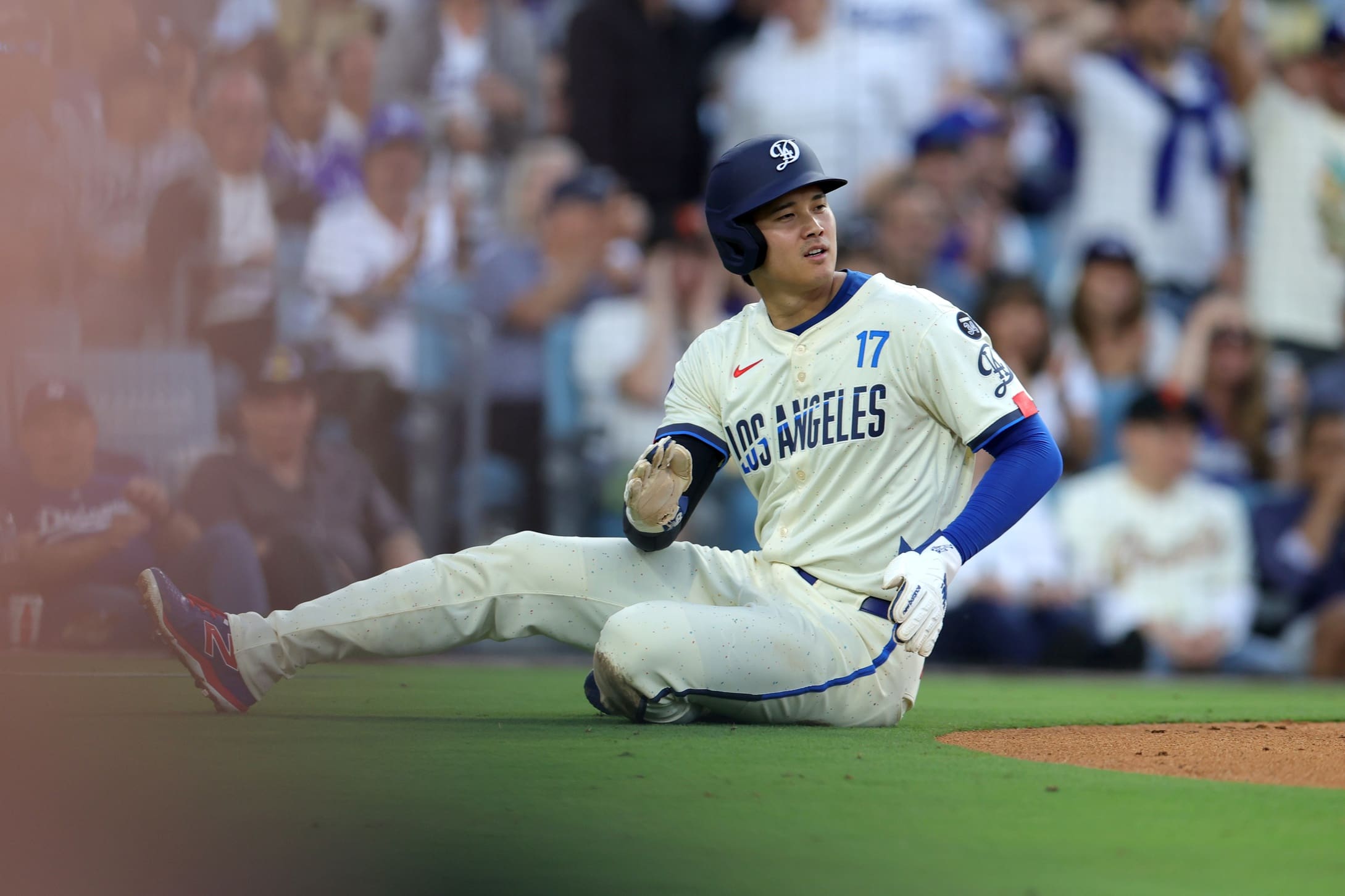Jun 14, 2025; Los Angeles, California, USA; Los Angeles Dodgers two-way player Shohei Ohtani (17) reacts after sliding at home plate after scoring a run against the San Francisco Giants in the second inning at Dodger Stadium. Mandatory Credit: Ryan Sun-Imagn Images