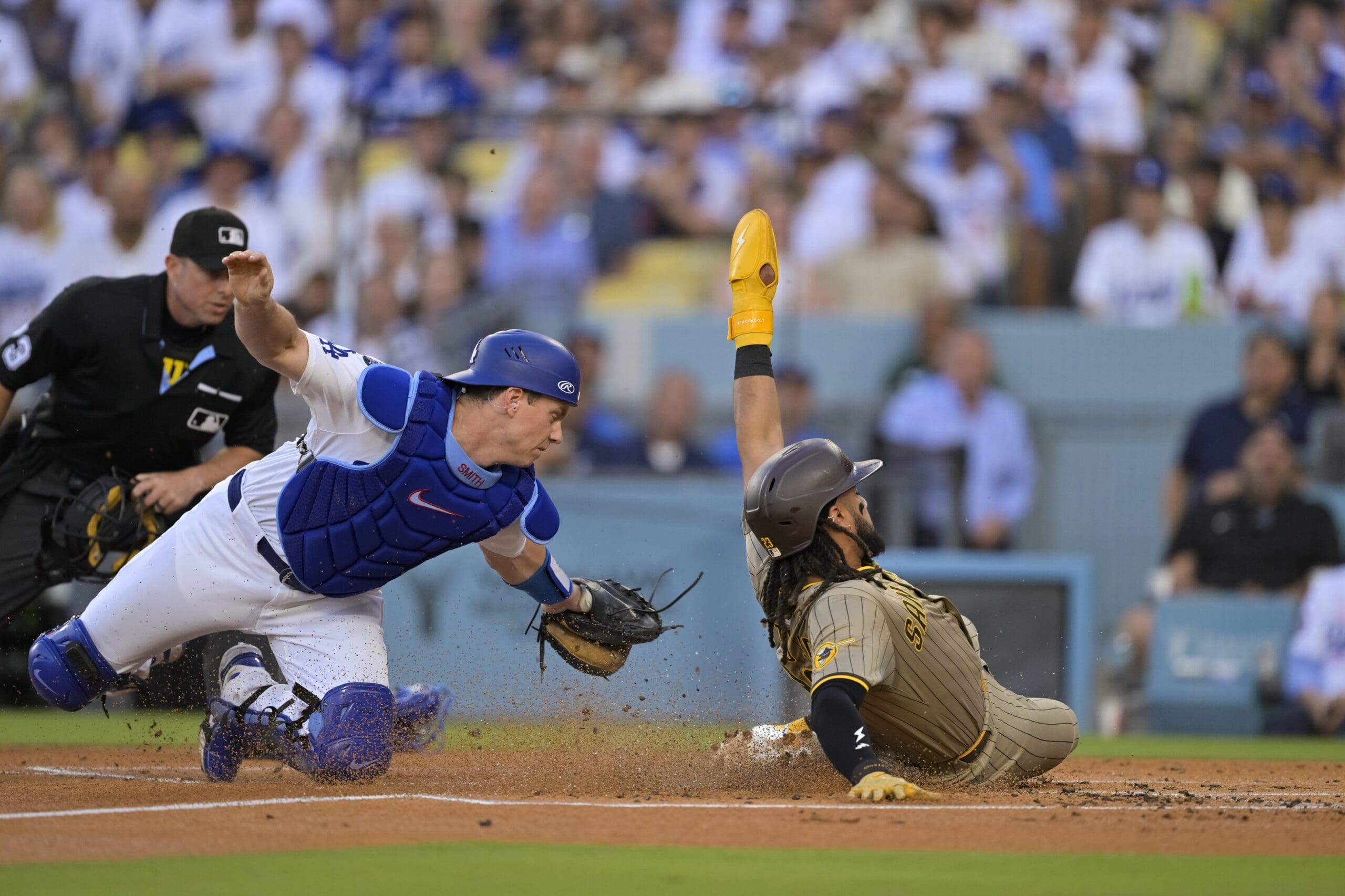Jun 16, 2025; Los Angeles, California, USA; San Diego Padres right fielder Fernando Tatis Jr. (23) scores as Los Angeles Dodgers catcher Will Smith (16) goes for the tag during the first inning at Dodger Stadium. Mandatory Credit: Jayne Kamin-Oncea-Imagn Images