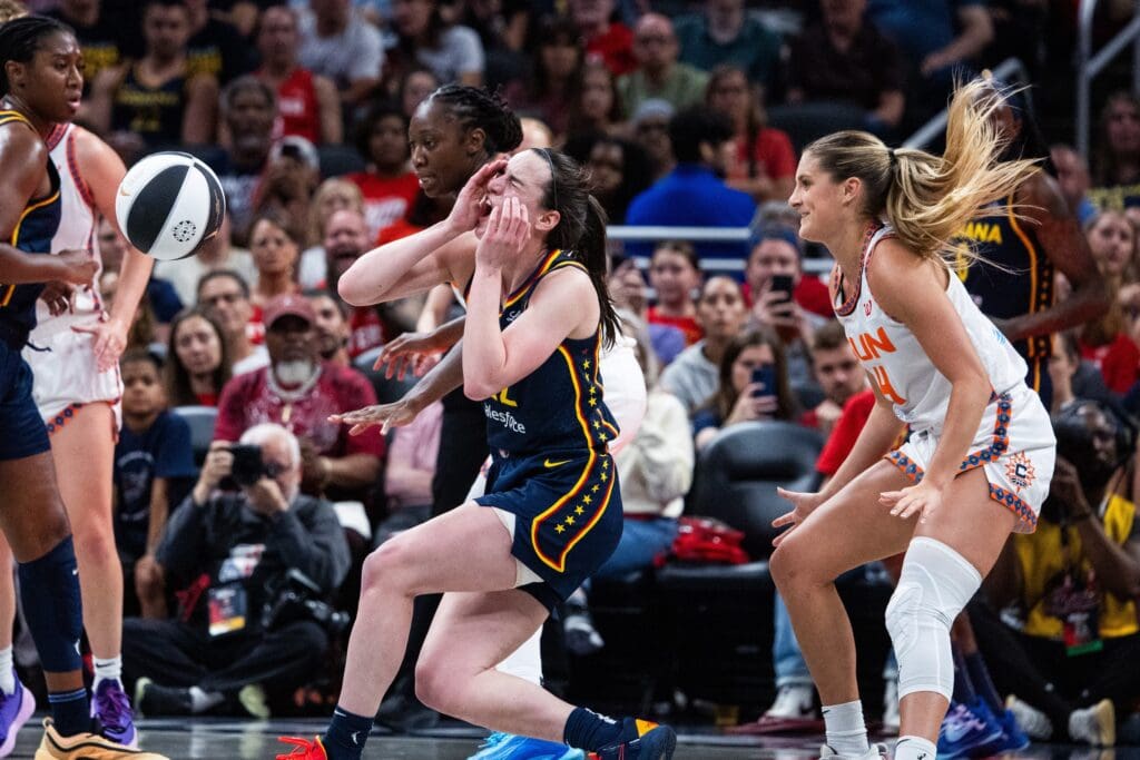 Jun 17, 2025; Indianapolis, Indiana, USA; Connecticut Sun guard Jacy Sheldon (4) fouls Indiana Fever guard Caitlin Clark (22) in the second half at Gainbridge Fieldhouse. Mandatory Credit: Trevor Ruszkowski-Imagn Images