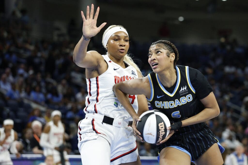 Jun 17, 2025; Chicago, Illinois, USA; Chicago Sky forward Angel Reese (5) drives to the basket against Washington Mystics forward Kiki Iriafen (44) during the first half of a WNBA game at Wintrust Arena. Mandatory Credit: Kamil Krzaczynski-Imagn Images