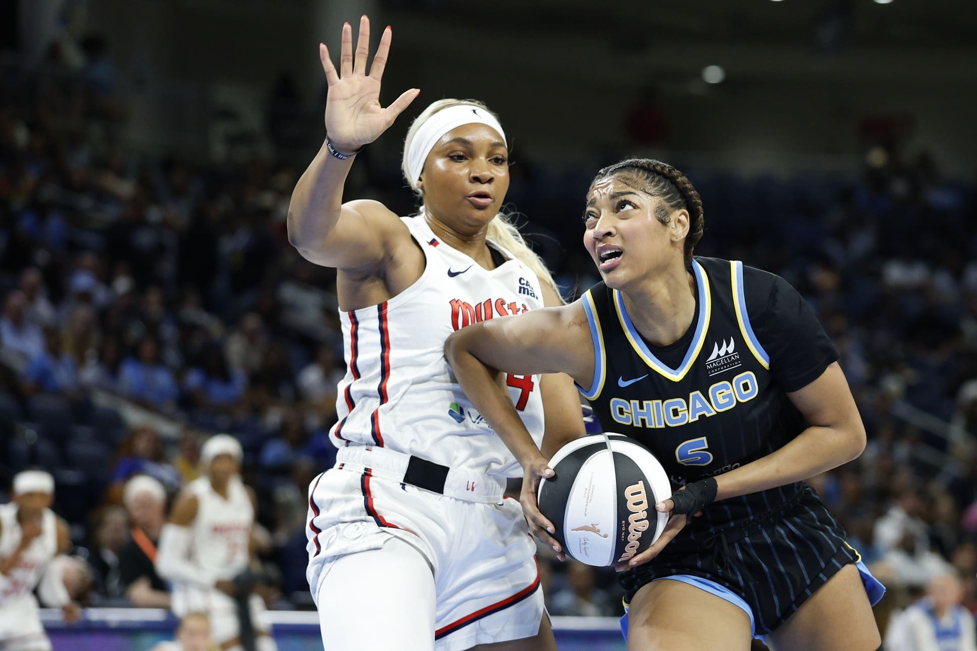 Jun 17, 2025; Chicago, Illinois, USA; Chicago Sky forward Angel Reese (5) drives to the basket against Washington Mystics forward Kiki Iriafen (44) during the first half of a WNBA game at Wintrust Arena. Mandatory Credit: Kamil Krzaczynski-Imagn Images