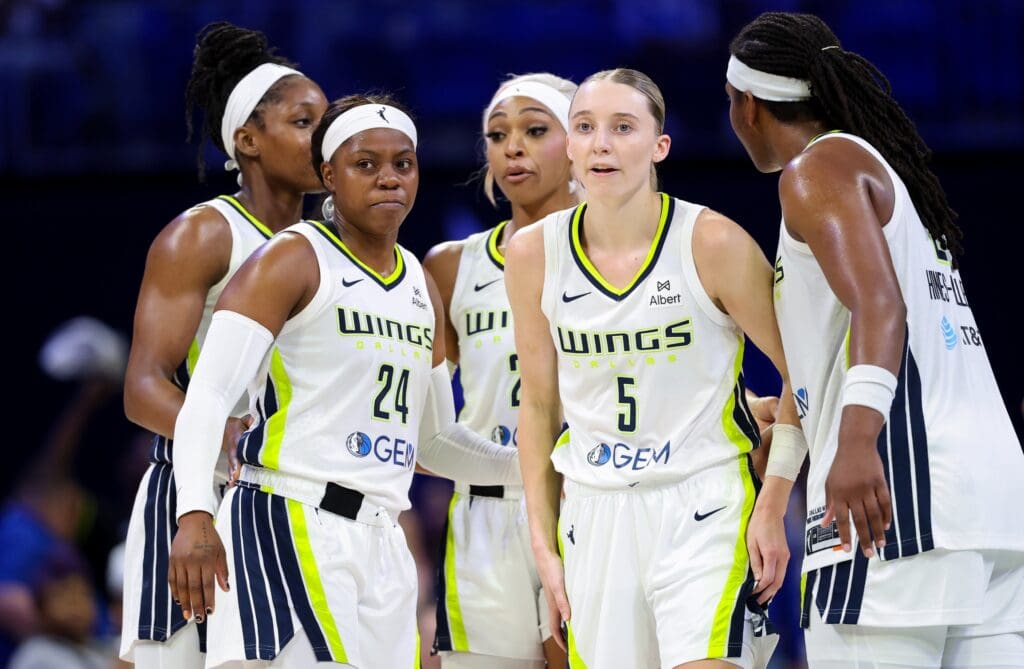 Jun 17, 2025; Arlington, Texas, USA; Dallas Wings guard Paige Bueckers (5) and Dallas Wings guard Arike Ogunbowale (24) celebrates with teammates during the second half against the Golden State Valkyries at College Park Center. Mandatory Credit: Kevin Jairaj-Imagn Images