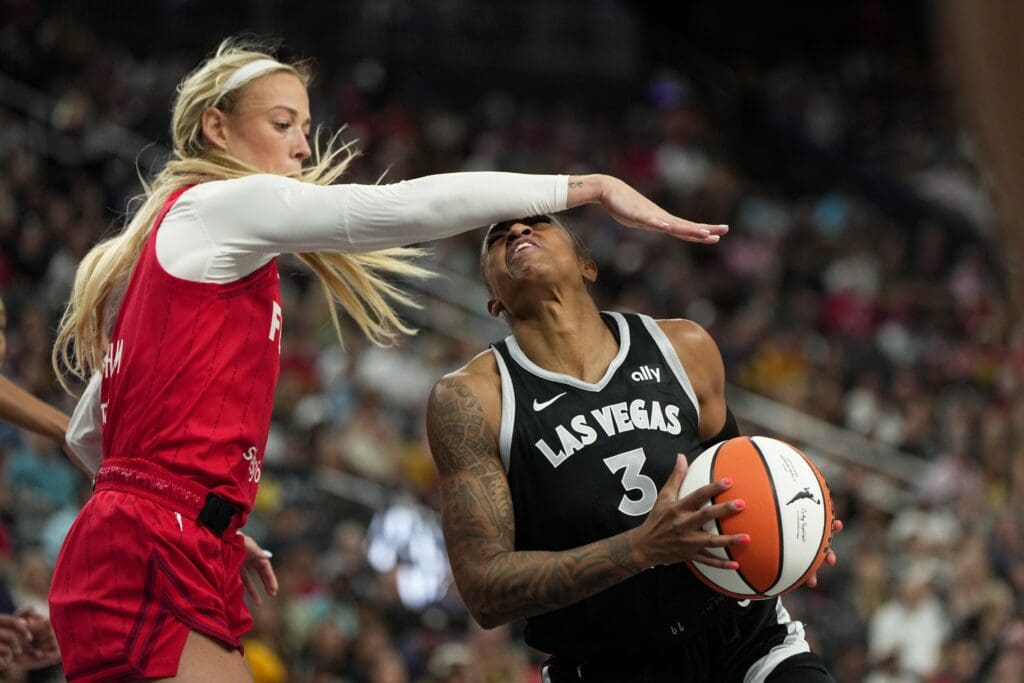 Jun 22, 2025; Las Vegas, Nevada, USA; Indiana Fever guard Sophie Cunningham (8) fouls Las Vegas Aces guard Tiffany Mitchell (3) during the first half of a WNBA basketball game at T-Mobile Arena. Mandatory Credit: Lucas Peltier-Imagn Images