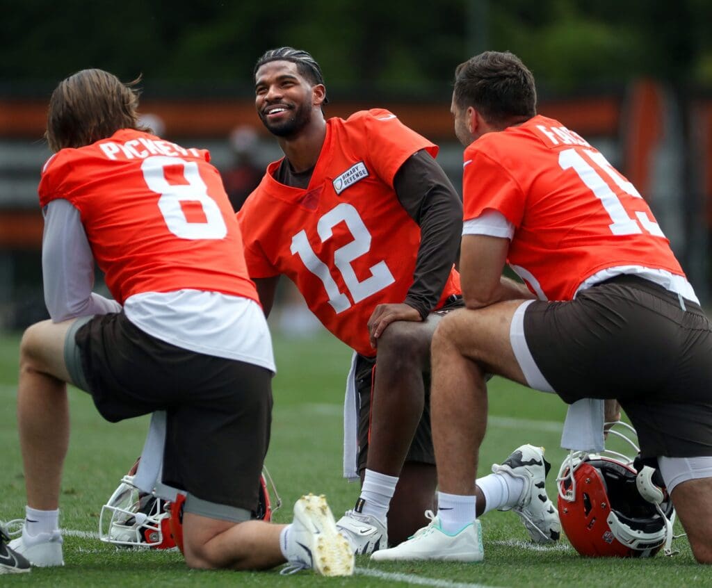 Browns quarterbacks Shedeur Sanders (12), Kenny Pickett (8) and Joe Flacco (15) talk during minicamp June 10, 2025, in Berea, Ohio.