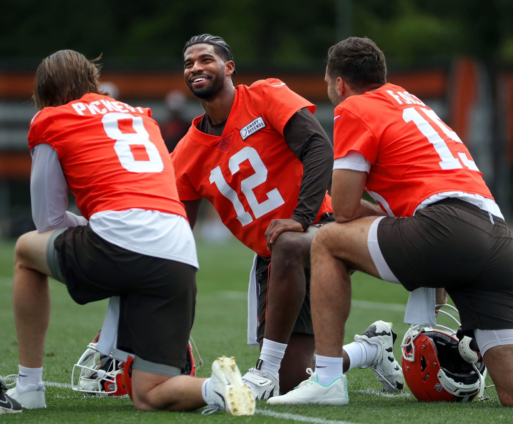 Browns quarterbacks Shedeur Sanders (12), Kenny Pickett (8) and Joe Flacco (15) talk during minicamp June 10, 2025, in Berea, Ohio.