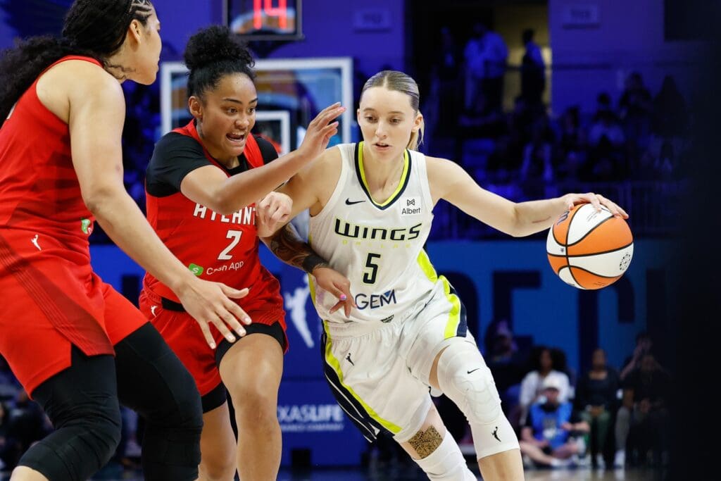 Jun 24, 2025; Arlington, Texas, USA; Dallas Wings guard Paige Bueckers (5) drives to the basket against Atlanta Dream guard Te-Hina Paopao (2) during the second half at College Park Center. Mandatory Credit: Chris Jones-Imagn Images