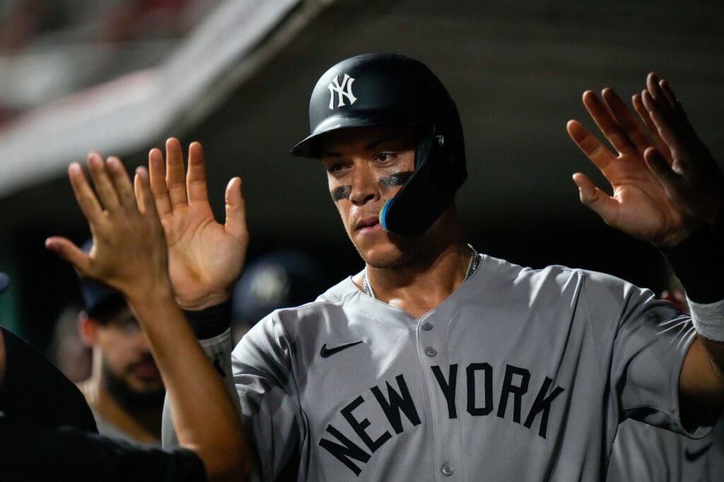 New York Yankees outfielder Aaron Judge (99) celebrates after scoring on a wild pitch to take the lead in the 11th inning of the MLB interleague game between the Cincinnati Reds and the New York Yankees at Great American Ball Park in downtown Cincinnati on Tuesday, June 24, 2025. The Reds won 5-4 in 11 innings.