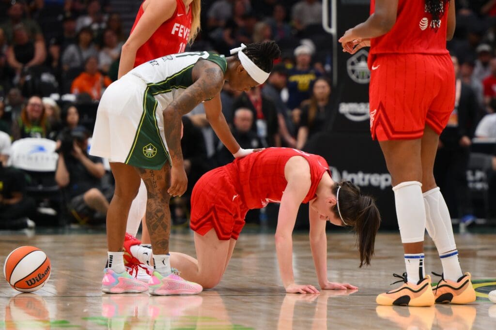 Jun 24, 2025; Seattle, Washington, USA; Seattle Storm guard Erica Wheeler (17) checks on Indiana Fever guard Caitlin Clark (22) during the second half at Climate Pledge Arena. Mandatory Credit: Steven Bisig-Imagn Images