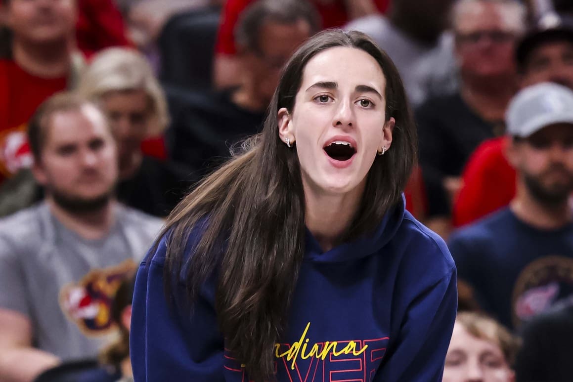 Jun 26, 2025; Indianapolis, Indiana, USA; Indiana Fever guard Caitlin Clark (22) reacts to the action against the Los Angeles Sparks during the first half at Gainbridge Fieldhouse. Mandatory Credit: Grace Smith/INDIANAPOLIS STAR-Imagn Images