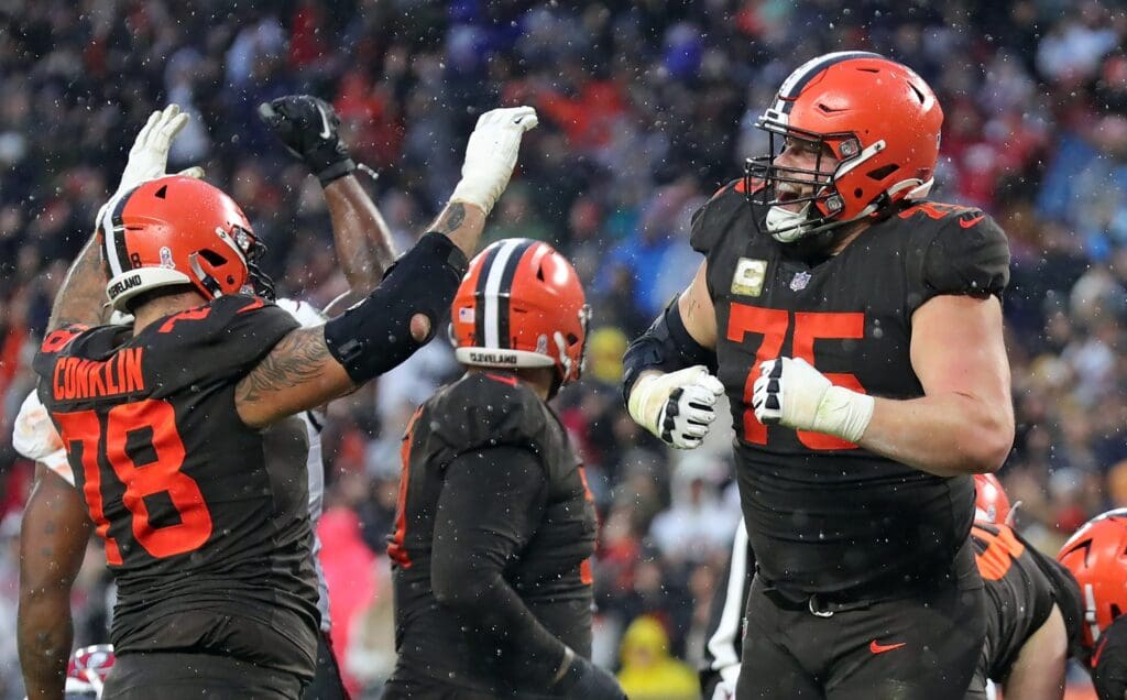 Browns guard Joel Bitonio (75) and tackle Jack Conklin (78) celebrate after Nick Chubb scored the game-winning touchdown in overtime against the Tampa Bay Buccaneers on Nov. 27, 2022, in Cleveland, Ohio.