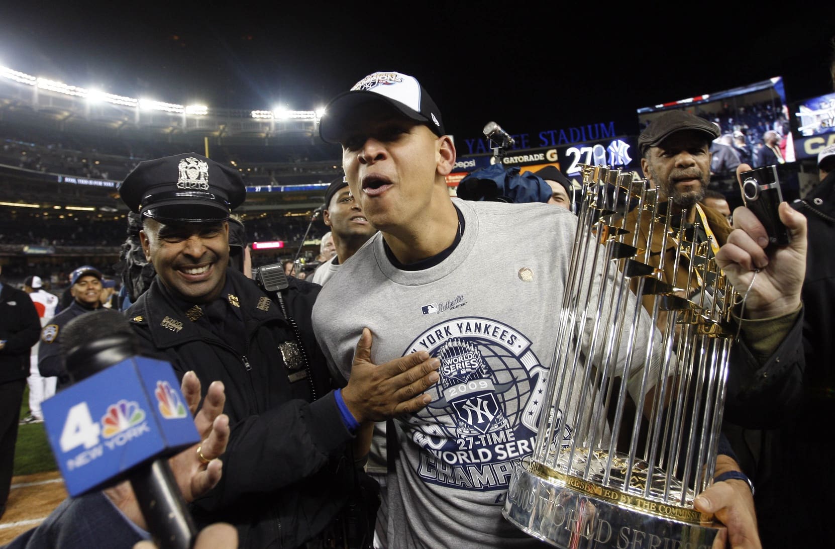Nov 4, 2009; Bronx, NY, USA; New York Yankees third baseman Alex Rodriguez carries the World Series championship trophy off the field after defeating the Philadelphia Phillies 7-3 in game six of the 2009 World Series at Yankee Stadium. Mandatory Credit: Jerry Lai-USA TODAY Sports