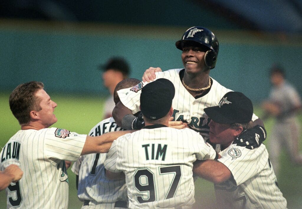 Sep 30, 1997; Miami, FL, USA: FILE PHOTO; Florida Marlins infielder Edgar Renteria is mobbed by teammates after driving in the winning run in the bottom of the 9th inning against the San Francisco Giants in game 1 of the 1997 NLDS at Dolphin Stadium. Mandatory Credit: USA TODAY Sports