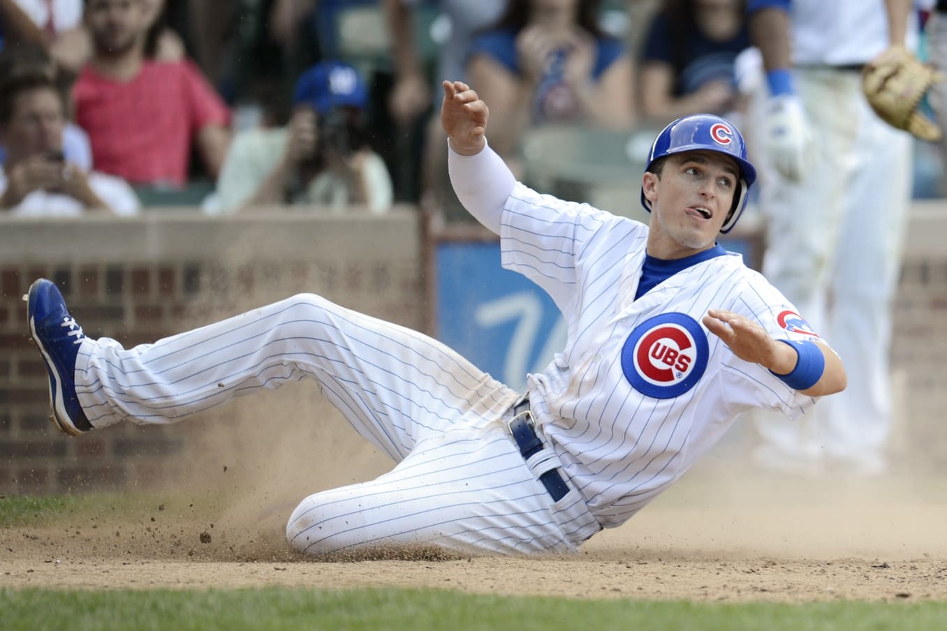 Chicago Cubs third baseman Josh Vitters reacts after being tagged out at home by the Colorado Rockies during the eighth inning at Wrigley Field. The Cubs won 5-3.
