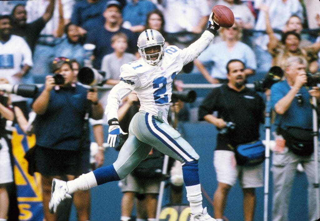 Sep 11, 1997; Irving, TX, USA; FILE PHOTO: Dallas Cowboys defensive back Deion Sanders (21) celebrating as he scores a touchdown on an interception against the Chicago Bears at Texas Stadium. Mandatory Credit: James D. Smith-USA TODAY Sports