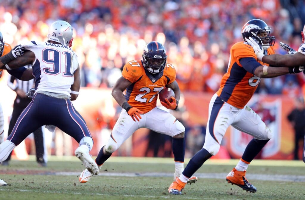 Jan 19, 2014; Denver, CO, USA; Denver Broncos running back Knowshon Moreno (27) rushes the ball against New England Patriots outside linebacker Jamie Collins (91) in the second half during the 2013 AFC championship playoff football game at Sports Authority Field at Mile High. Mandatory Credit: Mark J. Rebilas-USA TODAY Sports