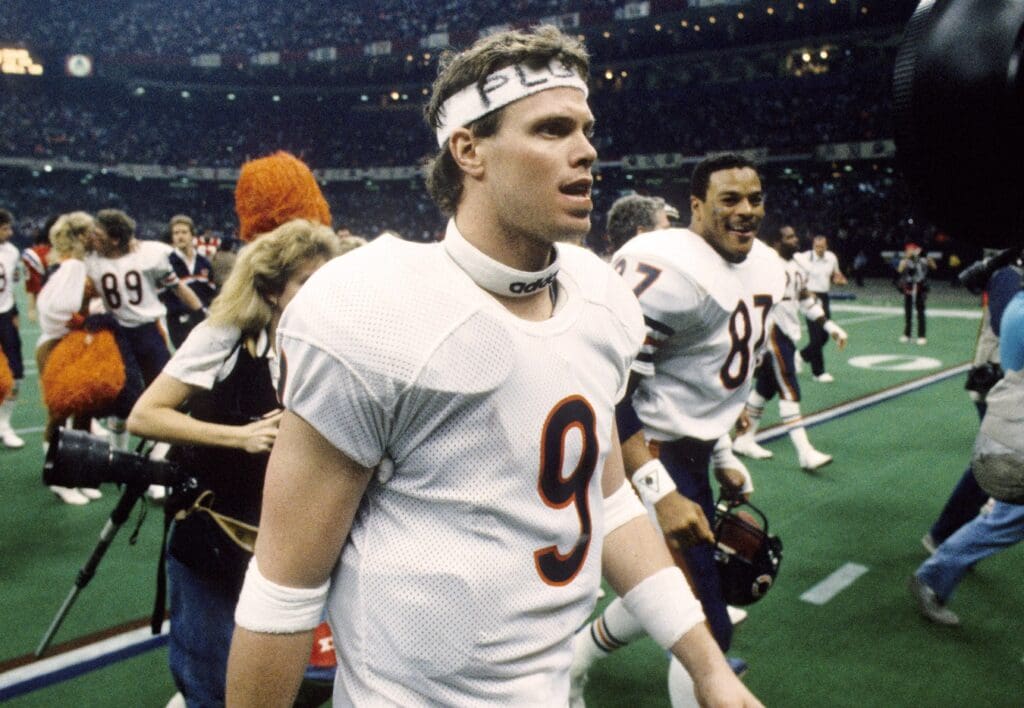 Jan 26, 1986; New Orleans, LA, USA; FILE PHOTO; Chicago Bears quarterback Jim McMahon (9), tight end Emery Moorehead (87) and teammates walk off the field after defeating the New England Patriots 46-10 to win Super Bowl XX at the Superdome. Mandatory Credit: Manny Rubio-USA TODAY Sports