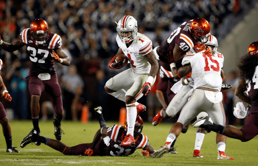 Ohio State Buckeyes wide receiver Braxton Miller (1) jump spins past Virginia Tech Hokies cornerback Brandon Facyson (31) and others for a touchdown run in the 3rd quarter at Lane Stadium in Blacksburg, Va on September 7, 2015. (Dispatch photo by Kyle Robertson)