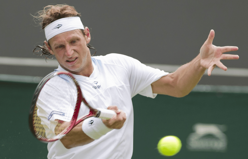 June 25, 2012; London, ENGLAND; David Nalbandian (ARG) returns a shot against Janko Tipsarevic (SRB) on day one of the 2012 Wimbledon Championships at the All England Lawn Tennis Club. Mandatory Credit: Susan Mullane-Imagn Images