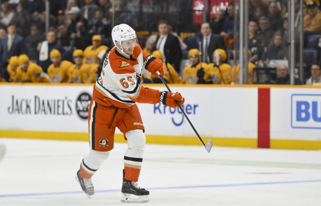 Mar 20, 2025; Nashville, Tennessee, USA; Anaheim Ducks defenseman Jacob Trouba (65) takes a shot on goal against the Nashville Predators during the second period at Bridgestone Arena. Mandatory Credit: Steve Roberts-Imagn Images