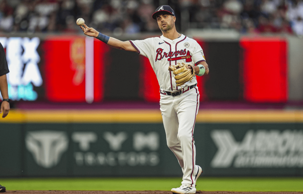 Sep 15, 2024; Cumberland, Georgia, USA; Atlanta Braves left fielder Whit Merrifield (15) throws out a Los Angeles Dodgers batter during the first inning at Truist Park. Mandatory Credit: Dale Zanine-Imagn Images