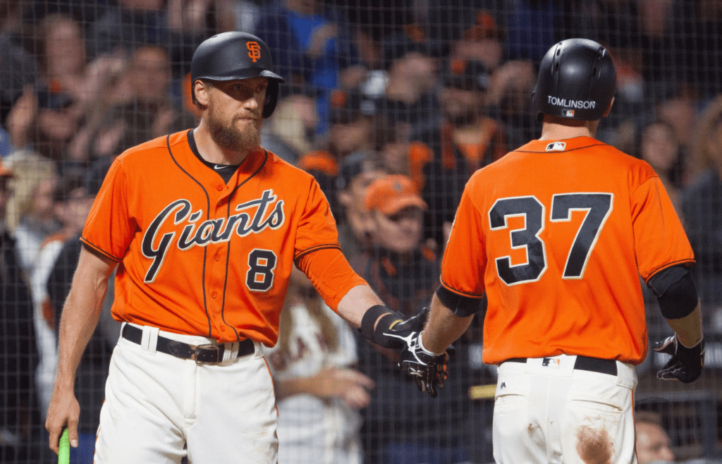 Aug 18, 2017; San Francisco, CA, USA; San Francisco Giants right fielder Hunter Pence (8) shakes hands with second baseman Kelby Tomlinson (37) after his run against the Philadelphia Phillies in the eighth inning at AT&T Park. Mandatory Credit: Andrew Villa-Imagn Images
