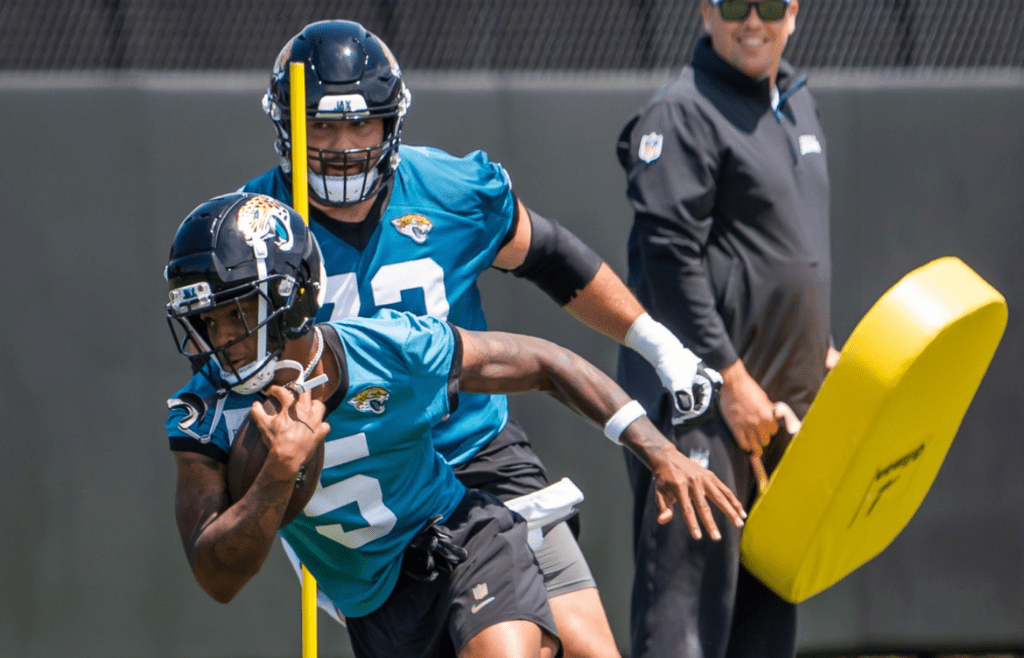 Jacksonville Jaguars wide receiver Dyami Brown (5) runs drill while being pursued by Jacksonville Jaguars center Robert Hainsey (73) during the fourth organized team activity at the Miller Electric Center in Jacksonville, Fla. Tuesday, May 27, 2025. [Doug Engle/Florida Times-Union]