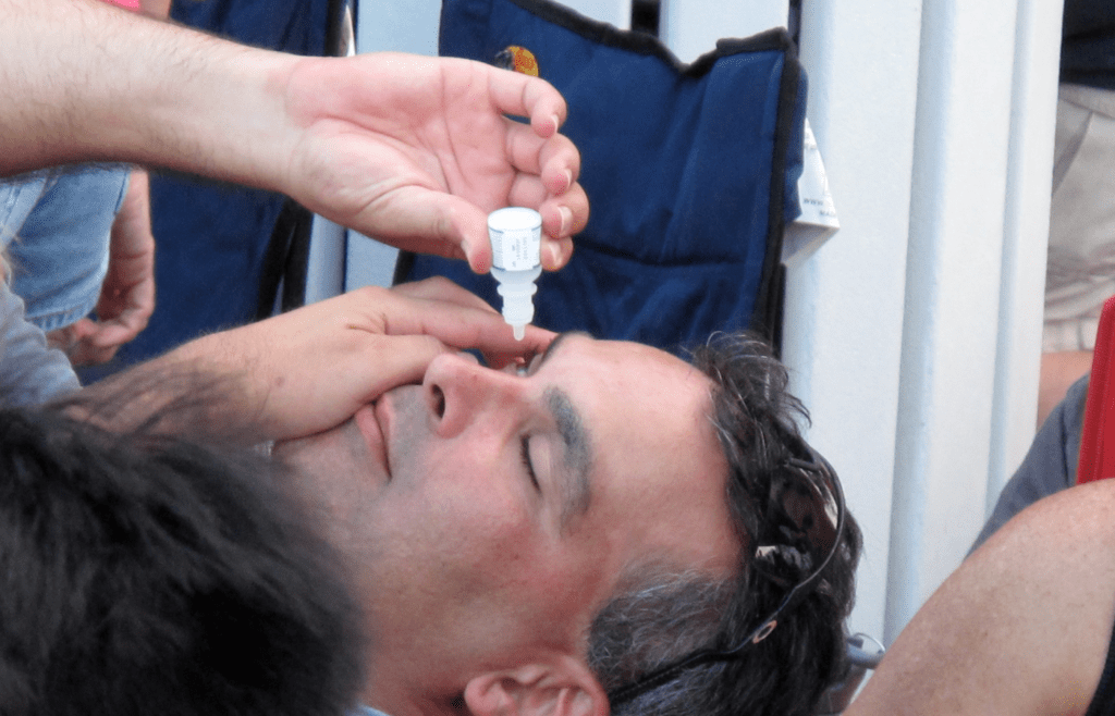 Man taking eyedrops