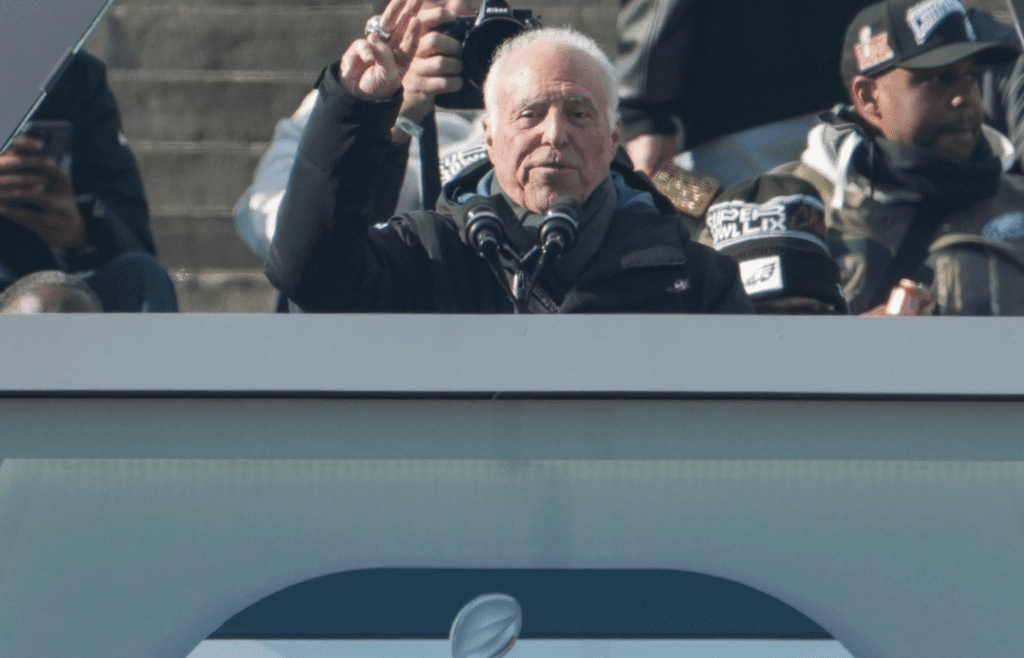 Eagles owner Jeffrey Lurie signals his interest in a third championship during the Philadelphia Eagles Super Bowl celebration in front of the Philadelphia Museum of Art, Friday, Feb. 14, 2025.